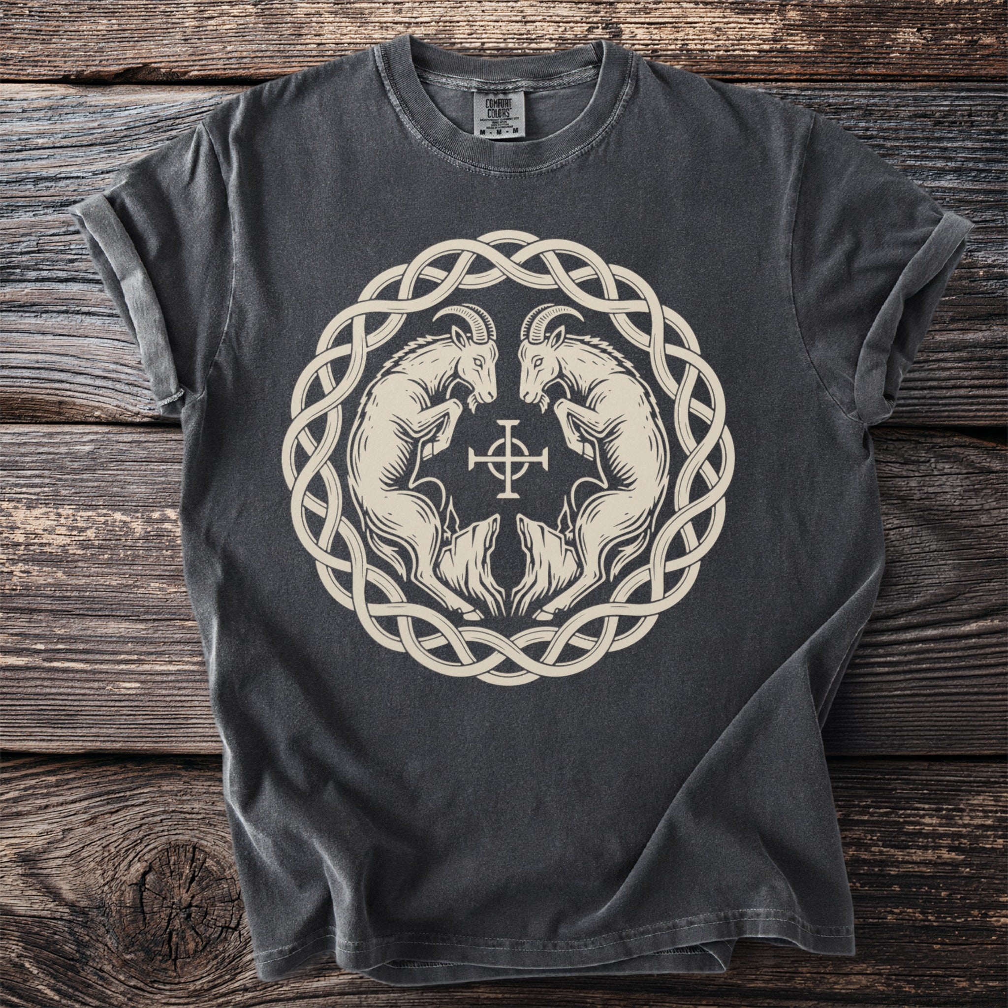 Dark grey t-shirt with a circular knot design featuring two goats and a cross.