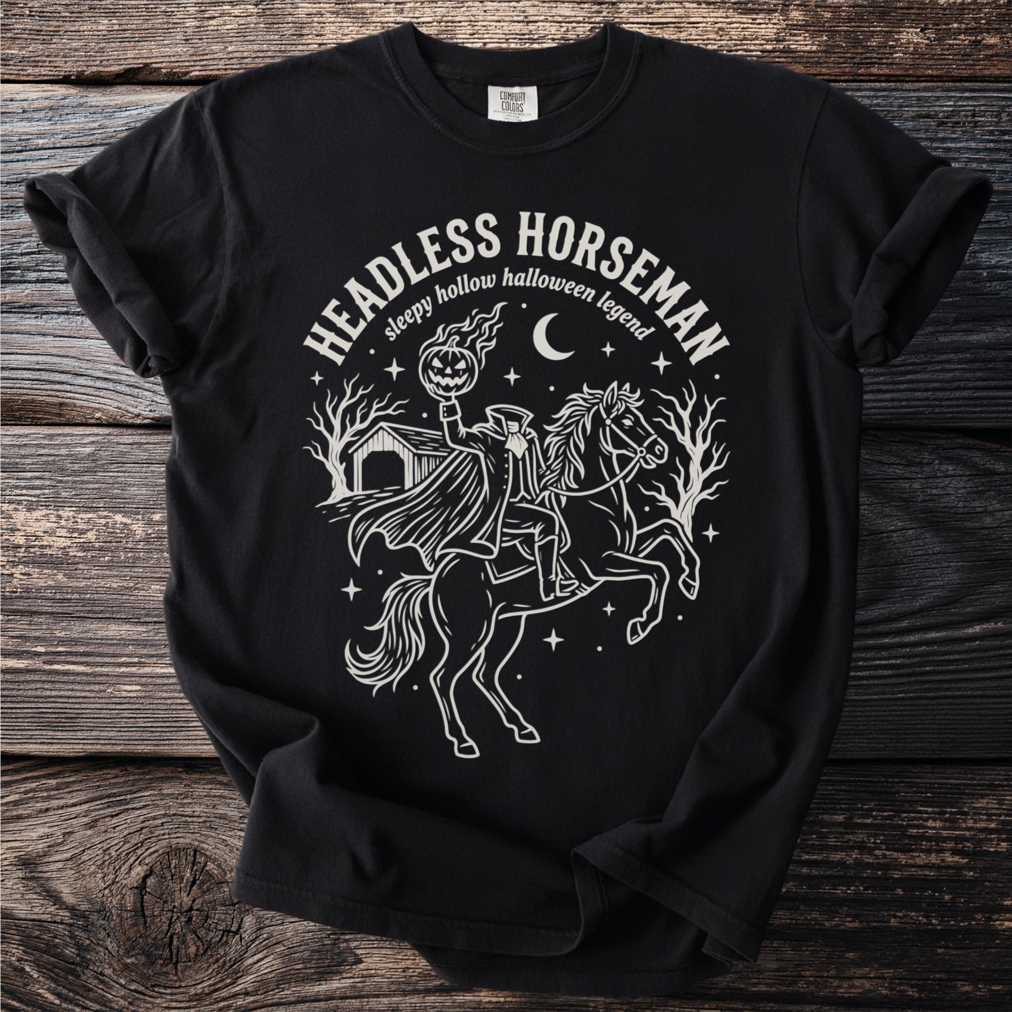 Black t-shirt with Headless Horseman, pumpkin, and sleepy hollow Halloween legend graphic.