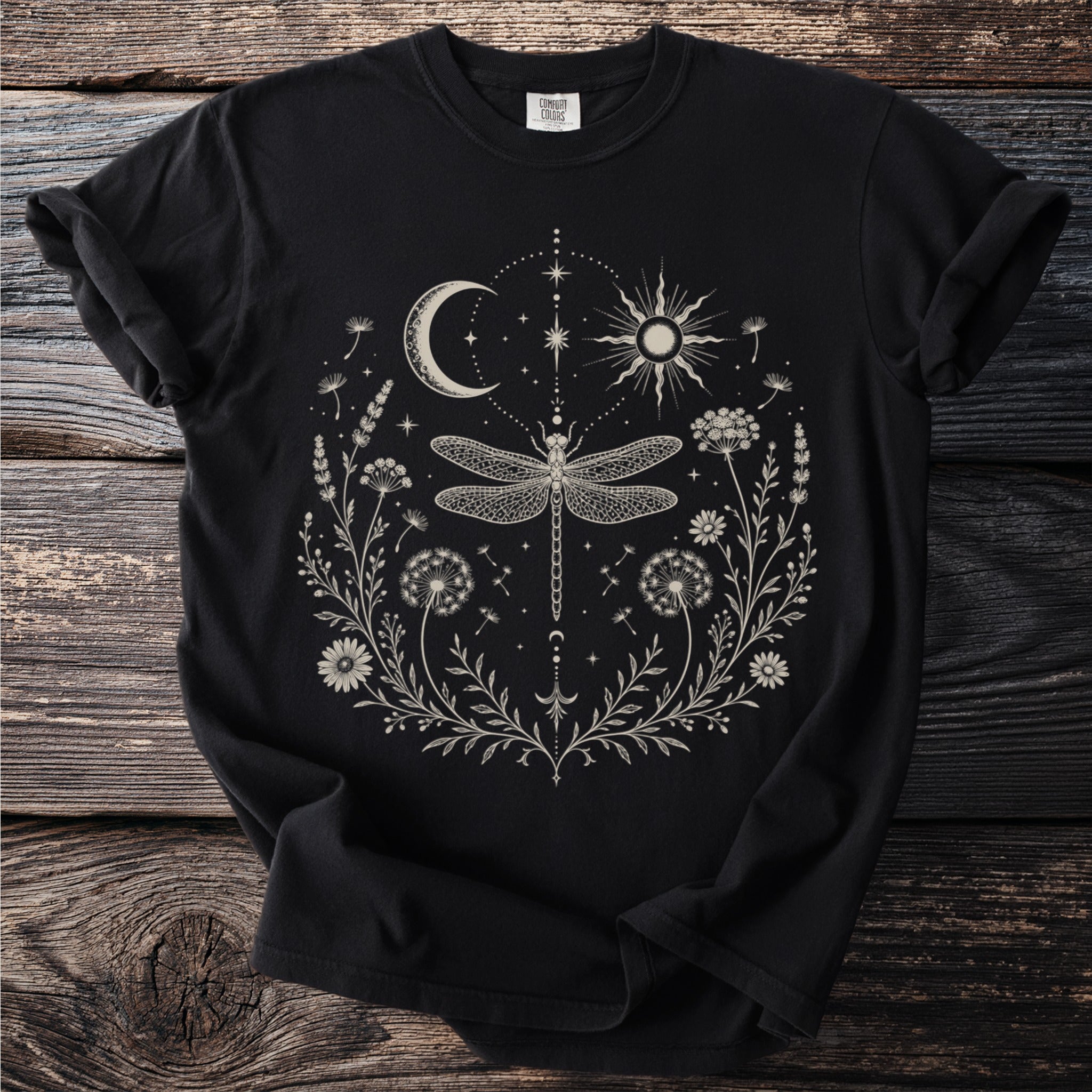 Black t-shirt with celestial and botanical print featuring a dragonfly, sun and moon.