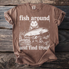 Brown t-shirt with a graphic of an opossum holding a trout and text that reads "fish around and find trout".