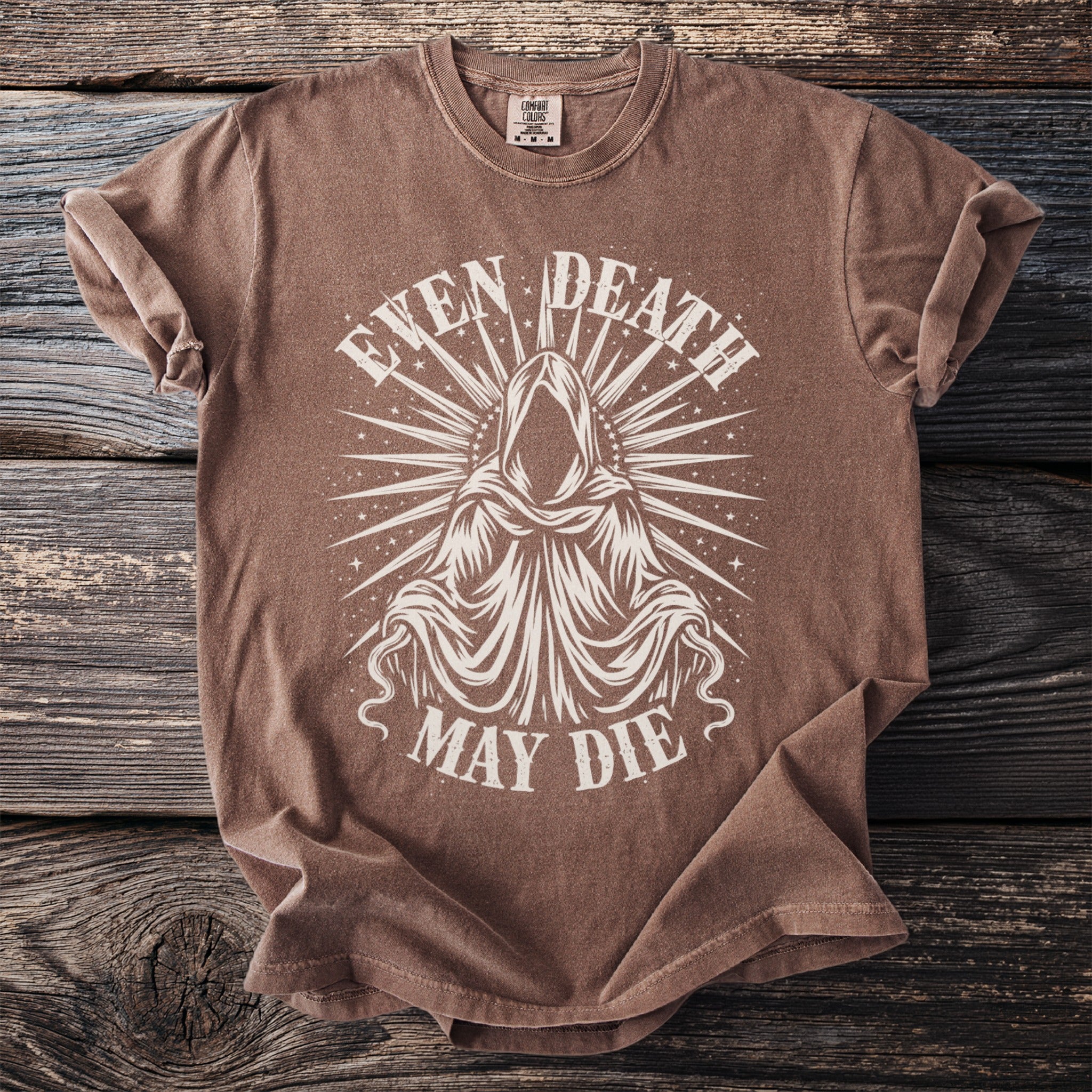 Brown t-shirt with a hooded figure graphic and text "EVEN DEATH MAY DIE".