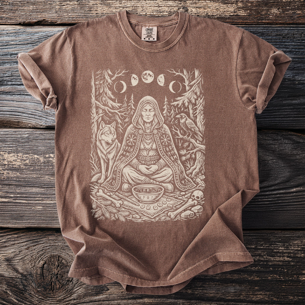 Brown t-shirt with a line art print of a robed figure, wolf, raven, and moon phases.