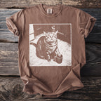 Brown t-shirt with graphic of a cat smoking a cigarette and holding a coffee mug.