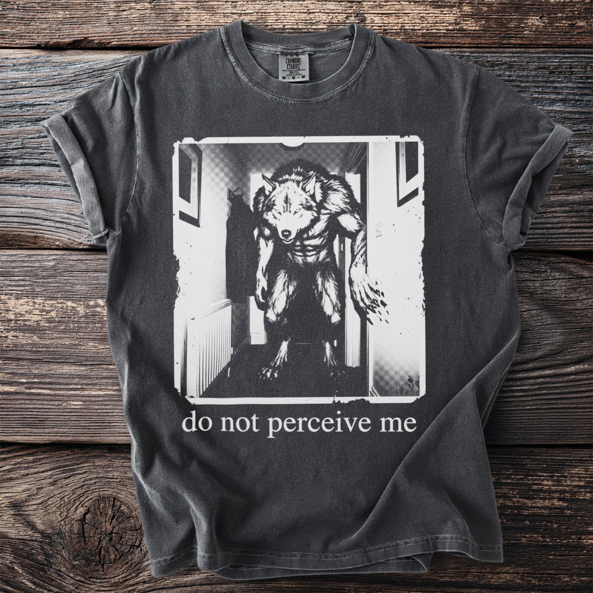 Dark gray t-shirt with a black and white graphic of a werewolf and text that reads "do not perceive me".