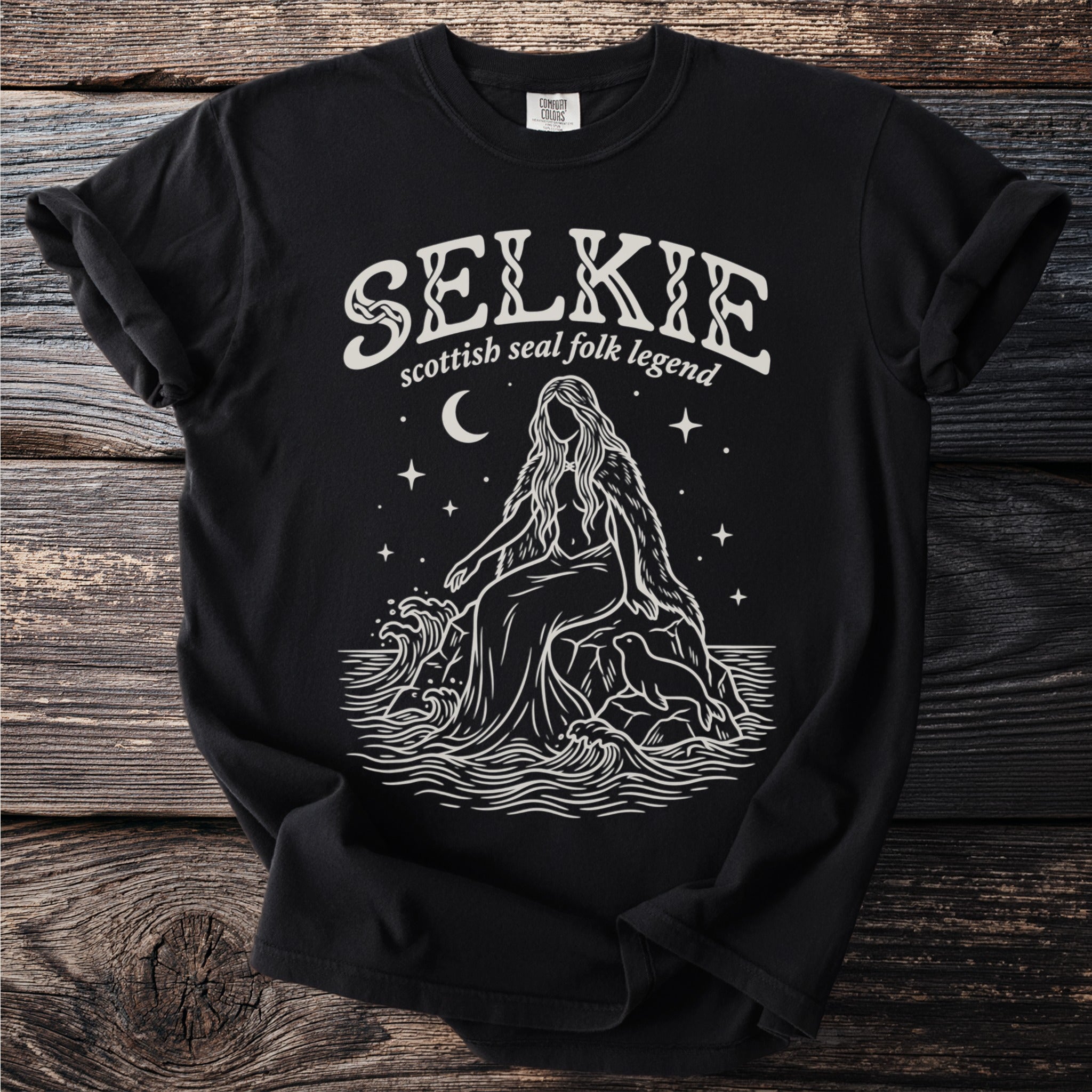 Black t-shirt with "Selkie Scottish Seal Folk Legend" text and a mythical sea creature.