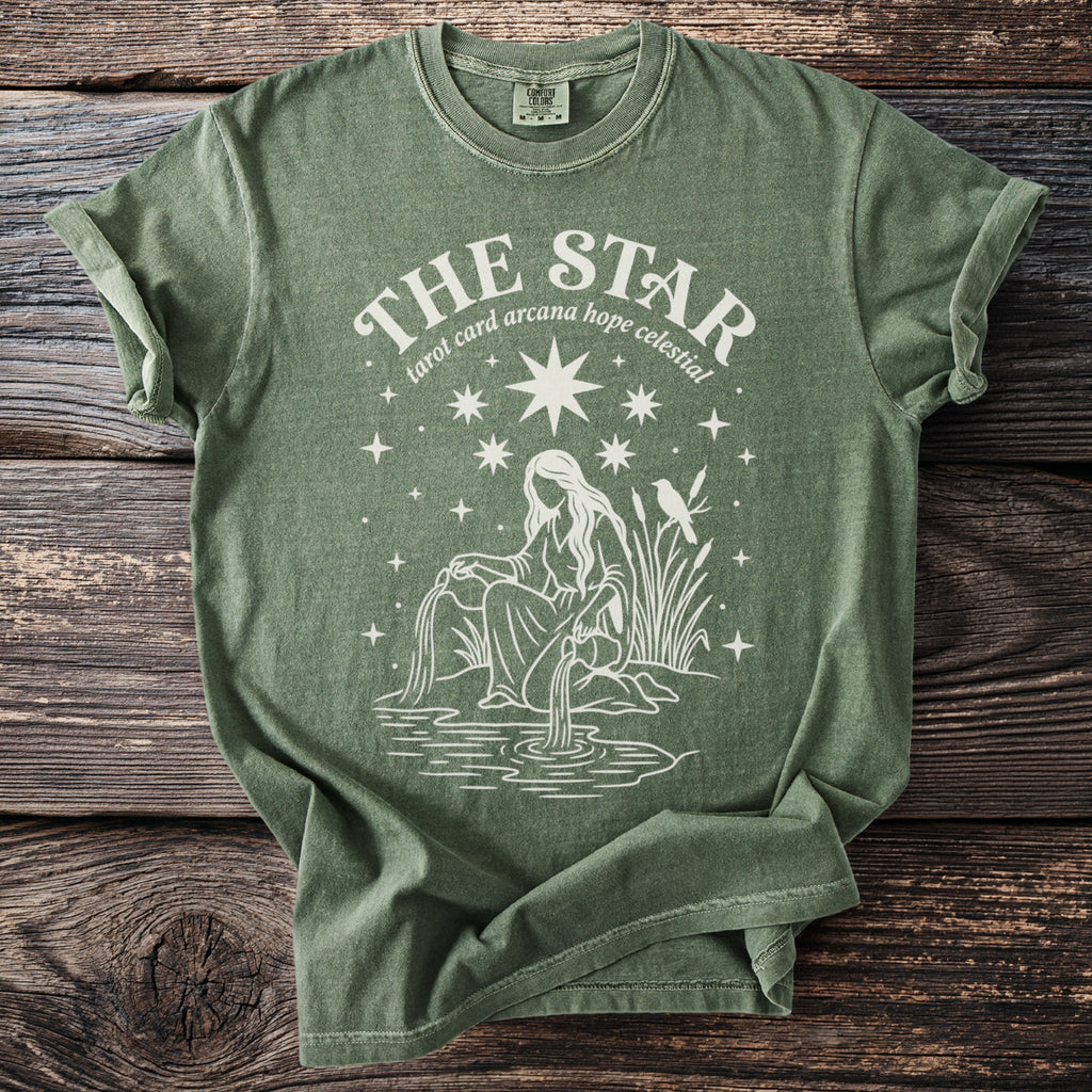 Green t-shirt with "The Star tarot card arcana hope celestial" text and celestial illustration.