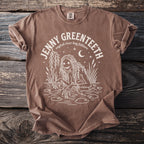 Brown t-shirt with white graphic of a swamp creature and text "JENNY GREENTEETH english river hag folklore".