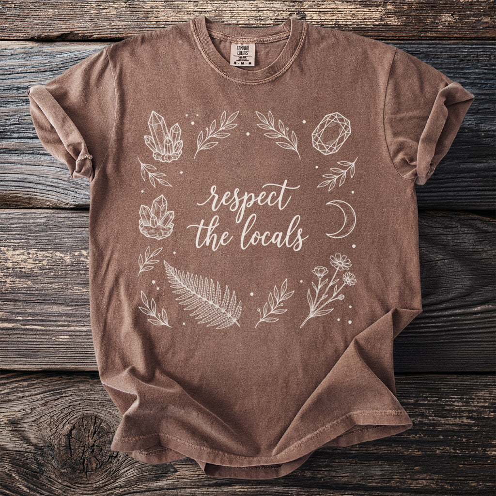 Brown t-shirt with "respect the locals" text and botanical illustrations.