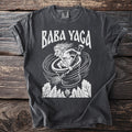 Dark grey t-shirt with white Baba Yaga graphic and white Comfort Colors tag.