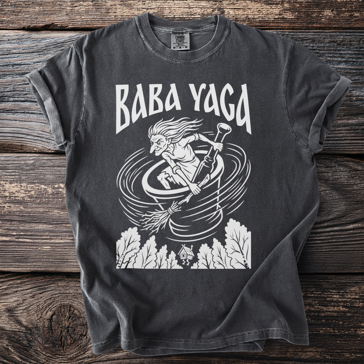 Dark grey t-shirt with white Baba Yaga graphic and white Comfort Colors tag.