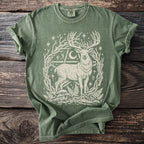 Green t-shirt with a white stag, moon, stars, and woodland elements print.