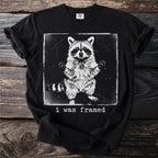 Black t-shirt with a distressed graphic of a raccoon and the text "i was framed".