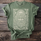 Green t-shirt with intricate forest spirit and woodland creatures design.