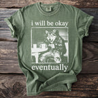 Green t-shirt with text "i will be okay eventually" and wolf graphic.