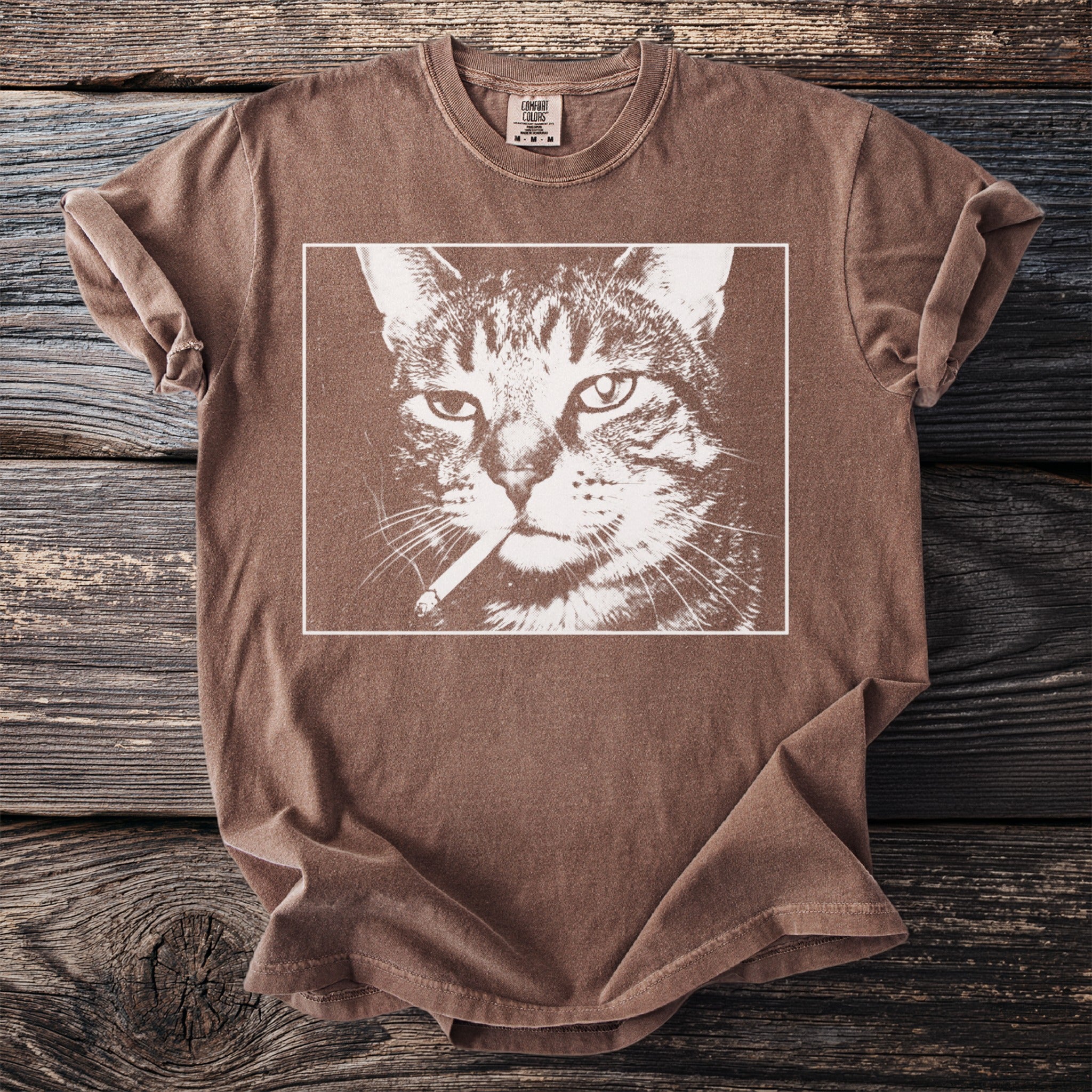 Brown t-shirt with a graphic of a tabby cat smoking a cigarette.