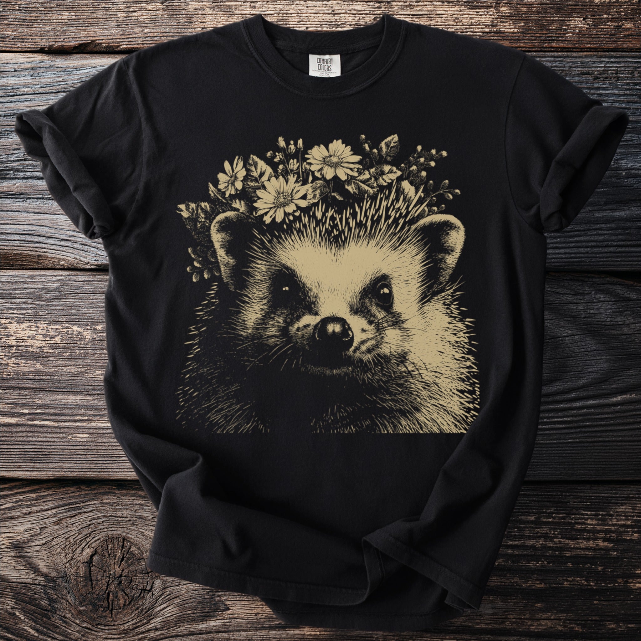 Black t-shirt with a line drawing of a hedgehog wearing a flower crown.