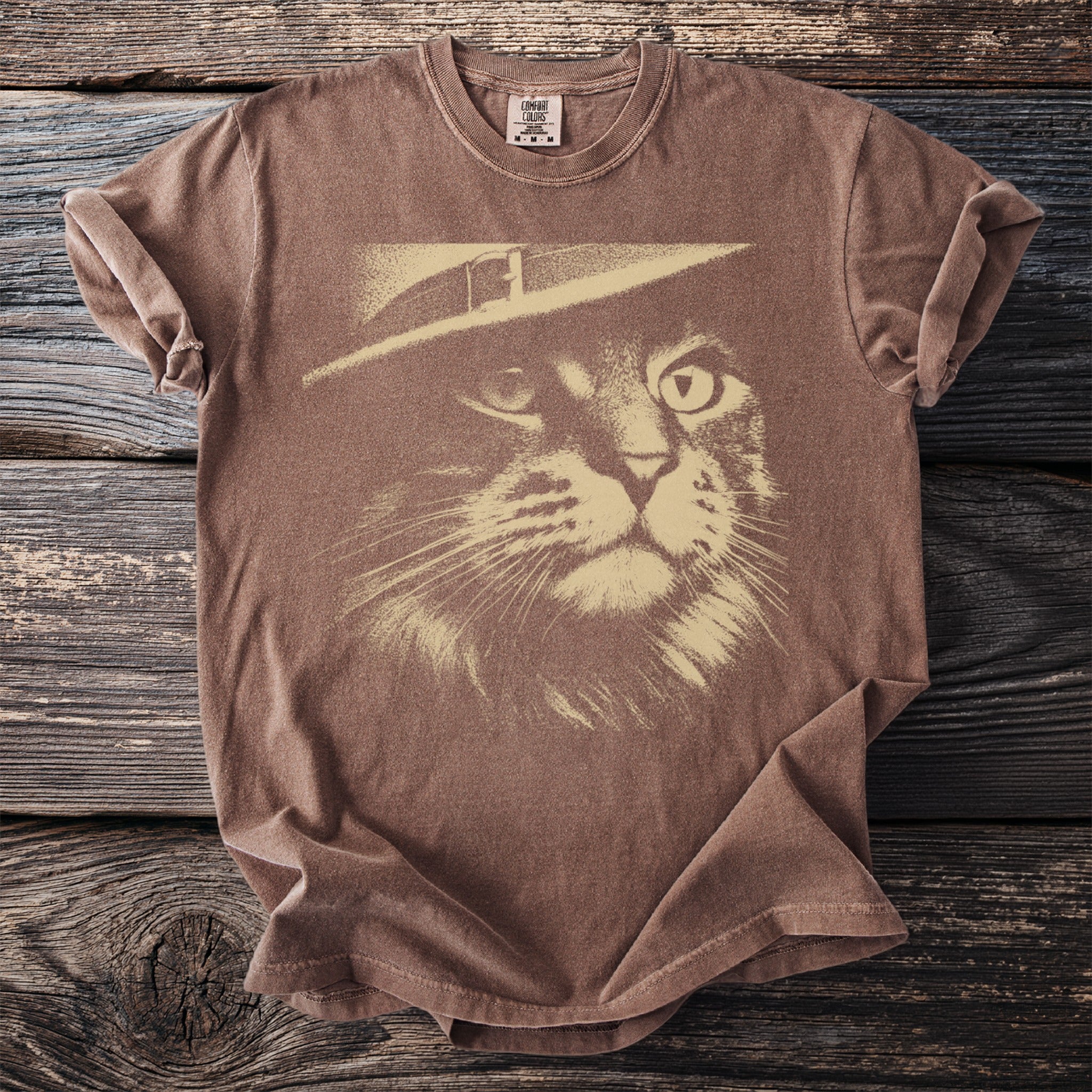 Brown t-shirt with a sepia-toned cat wearing a hat graphic and Comfort Colors tag.