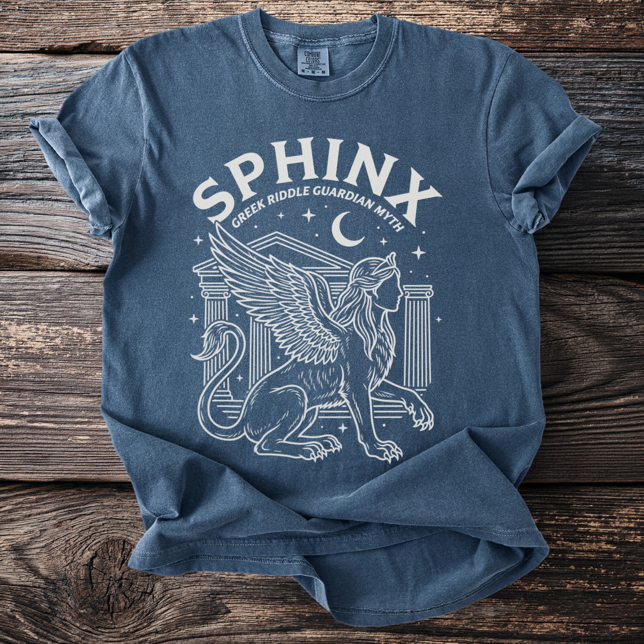Blue t-shirt with white line art of a sphinx and text "SPHINX GREEK RIDDLE GUARDIAN MYTH".