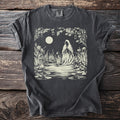 Dark gray t-shirt with a cream-colored graphic of a cloaked figure at a moonlit pond.