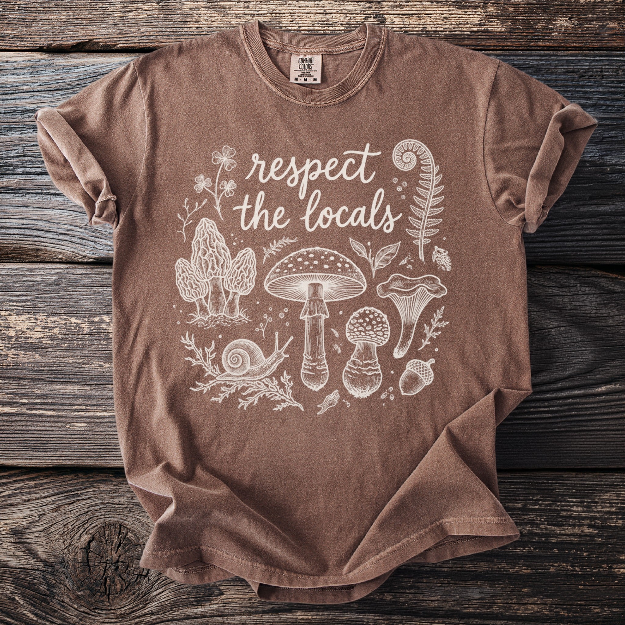 Brown t-shirt with white "respect the locals" text and mushroom illustrations.