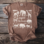 Brown t-shirt with white graphic of African animals and text "respect the locals."