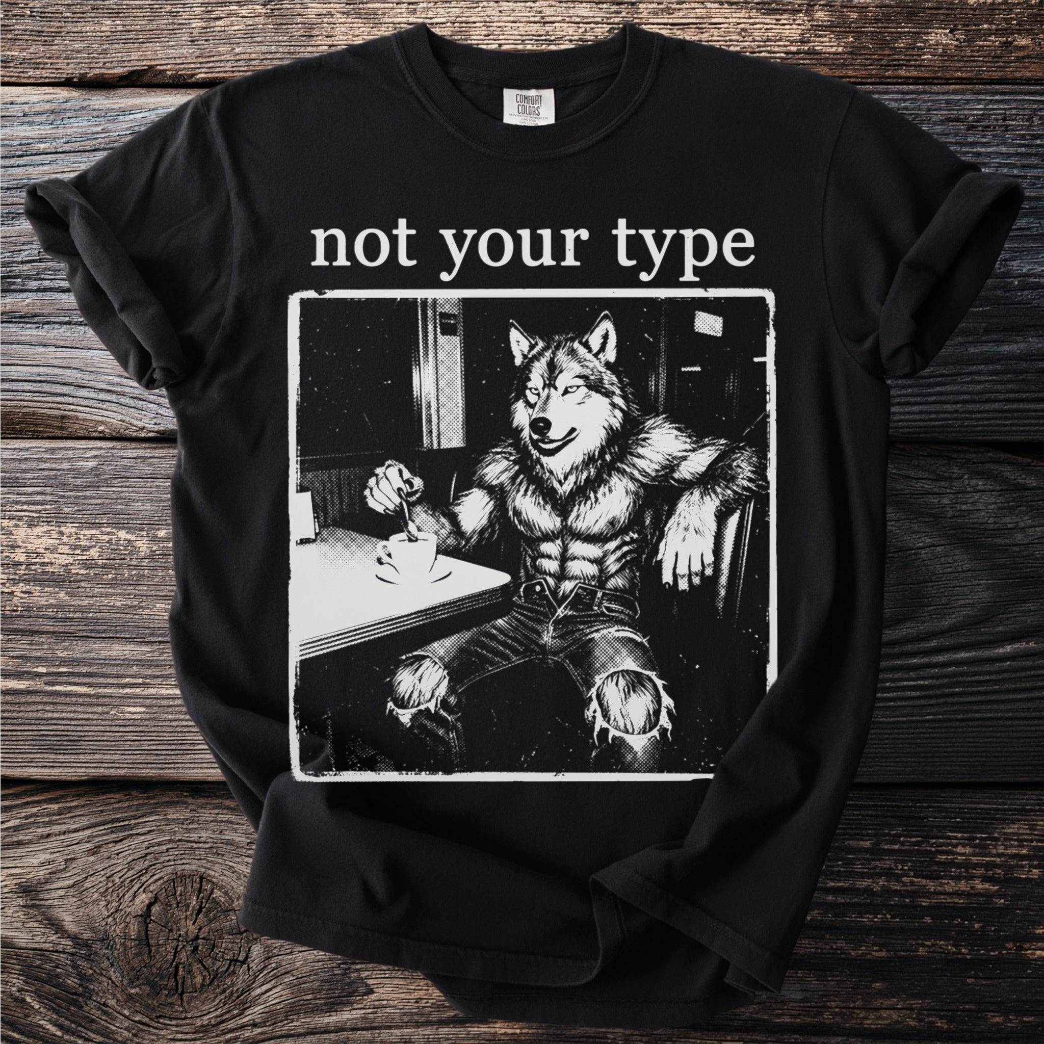 Black t-shirt with a wolf man text "not your type" and comic-style illustration.