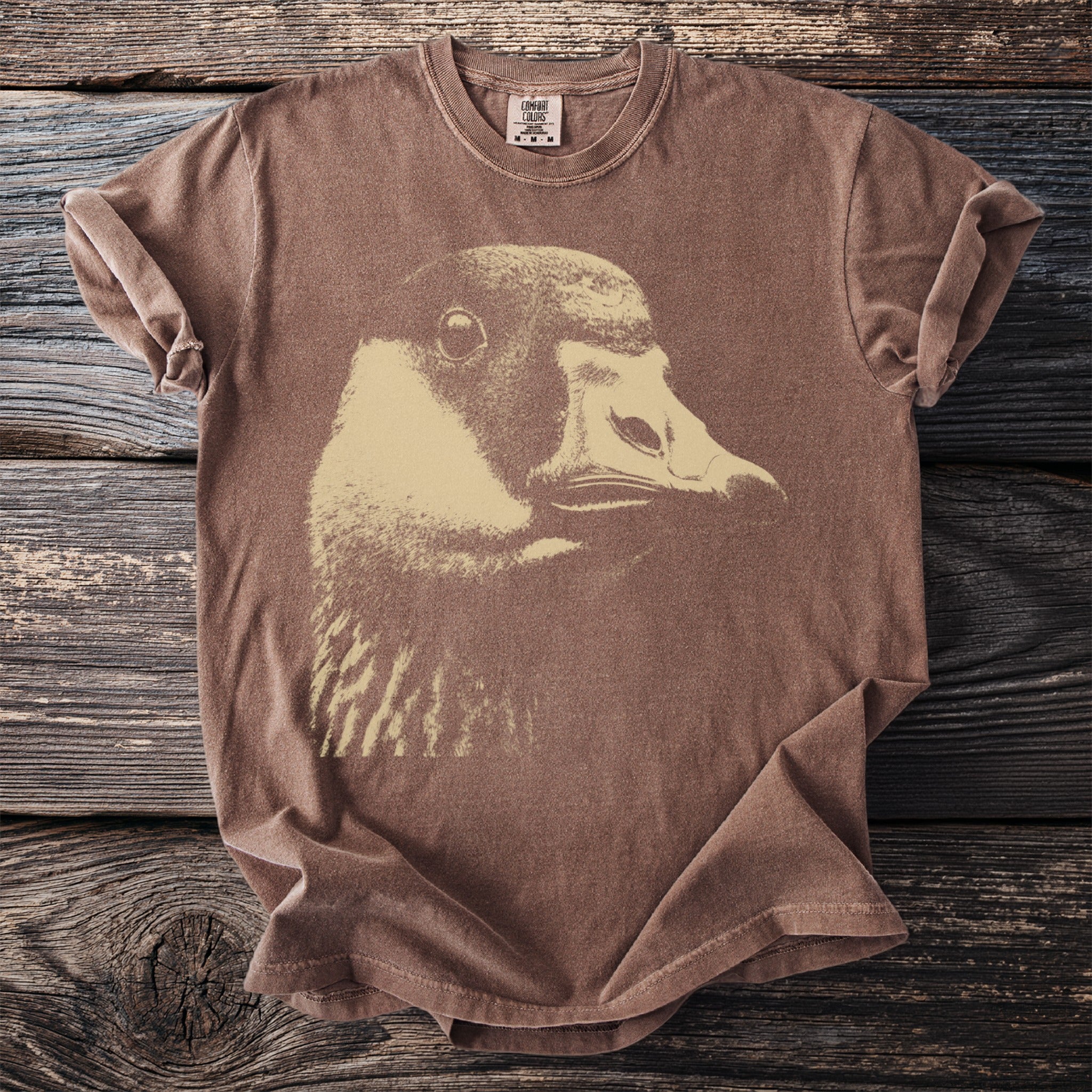 Brown t-shirt with a close-up graphic of a goose's head.