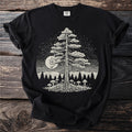 Black t-shirt with graphic of a tree, moon, mushrooms, and forest.