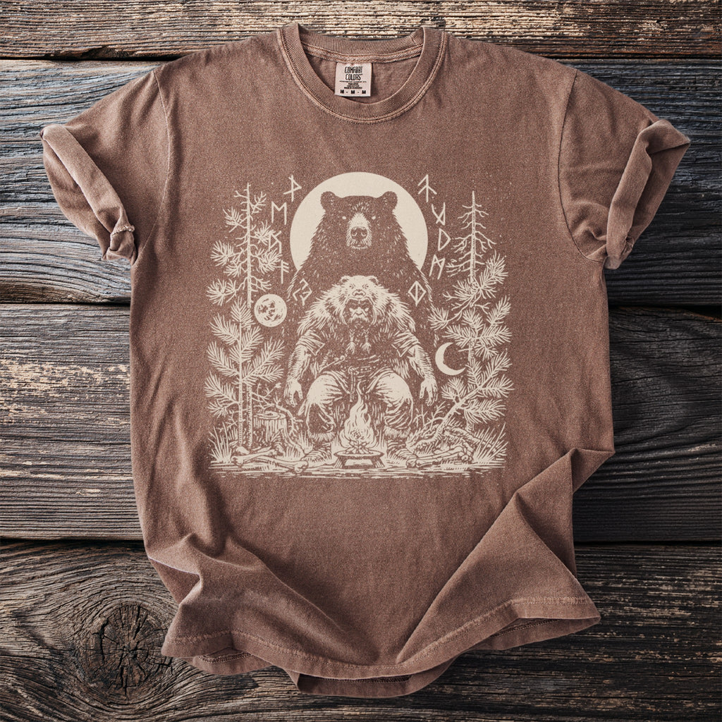 Brown t-shirt with a mystical forest scene featuring a bear spirit and campfire artwork.