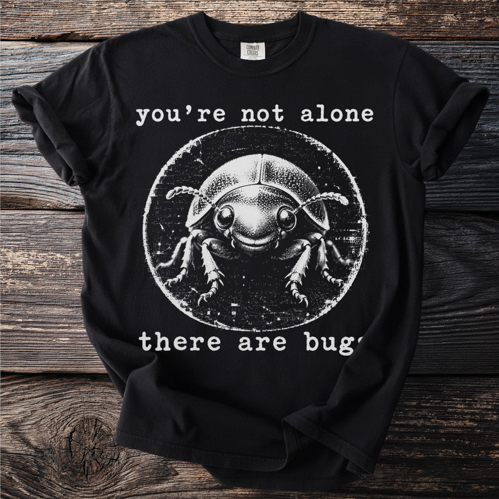 Black t-shirt with white graphic of a beetle and text "you're not alone there are bugs".