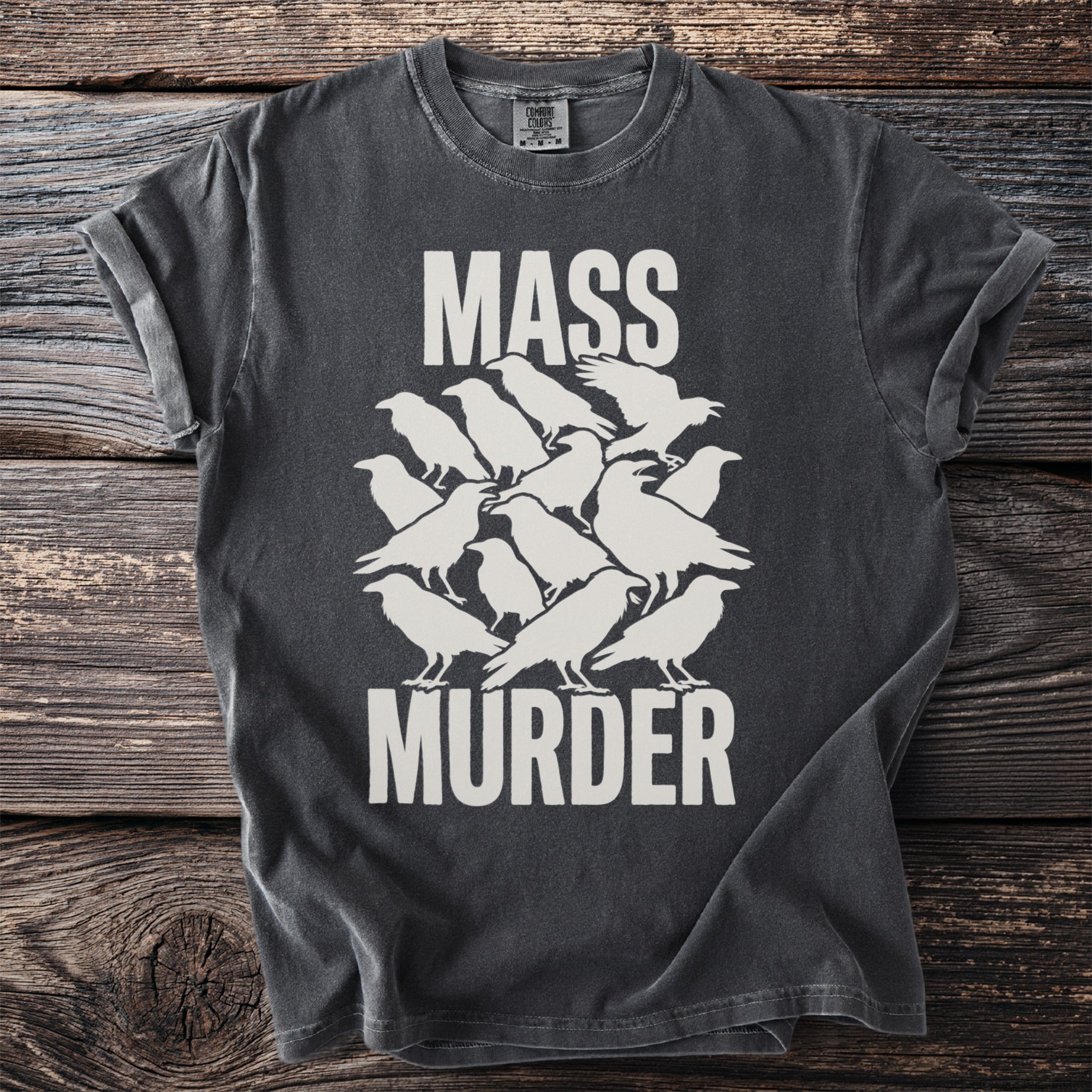 Dark grey shirt with white text "MASS MURDER" above a stylized flock of crows.