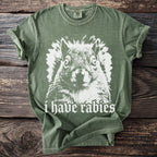 Green t-shirt with a white graphic of a squirrel and "i have rabies" text.