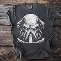 Dark t-shirt with a white graphic of a tentacled creature and a lighthouse.