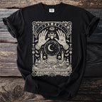 Black t-shirt with a mystical design featuring a crystal ball, hands, and mystical symbols.