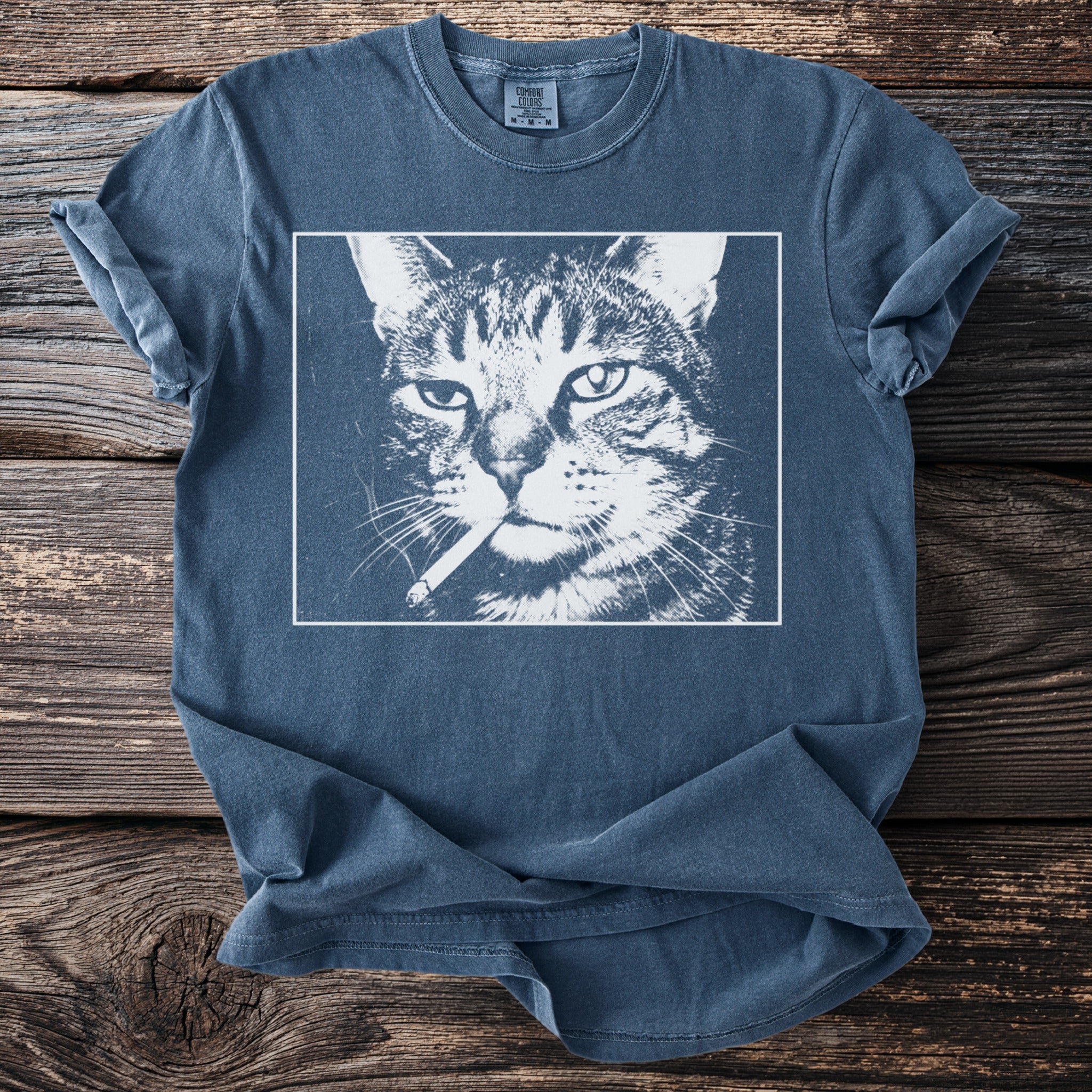 Blue t-shirt with a graphic of a cat smoking a cigarette.