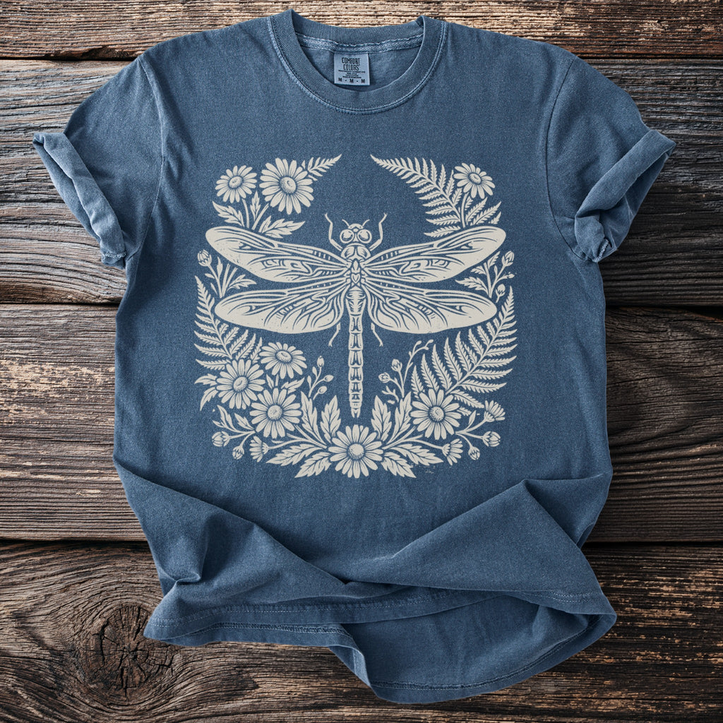 Blue t-shirt with a cream dragonfly and floral design.