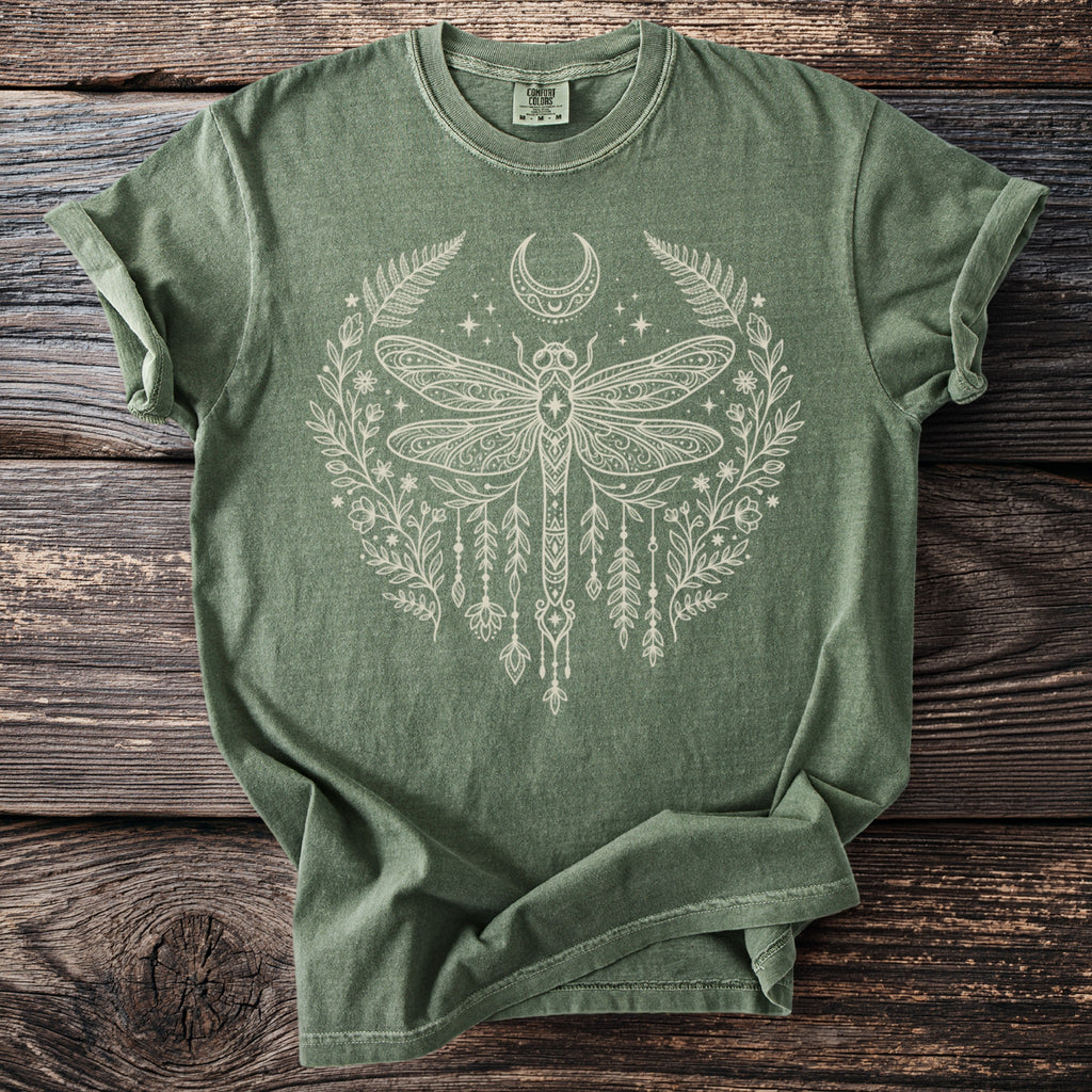 Green Comfort Colors t-shirt with white dragonfly, moon, and floral graphic.