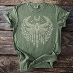 Green Comfort Colors t-shirt with white dragonfly, moon, and floral graphic.