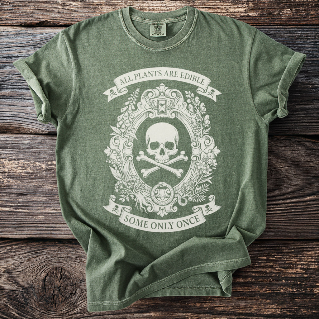 Green t-shirt with a skull and crossbones emblem and text "ALL PLANTS ARE EDIBLE SOME ONLY ONCE".