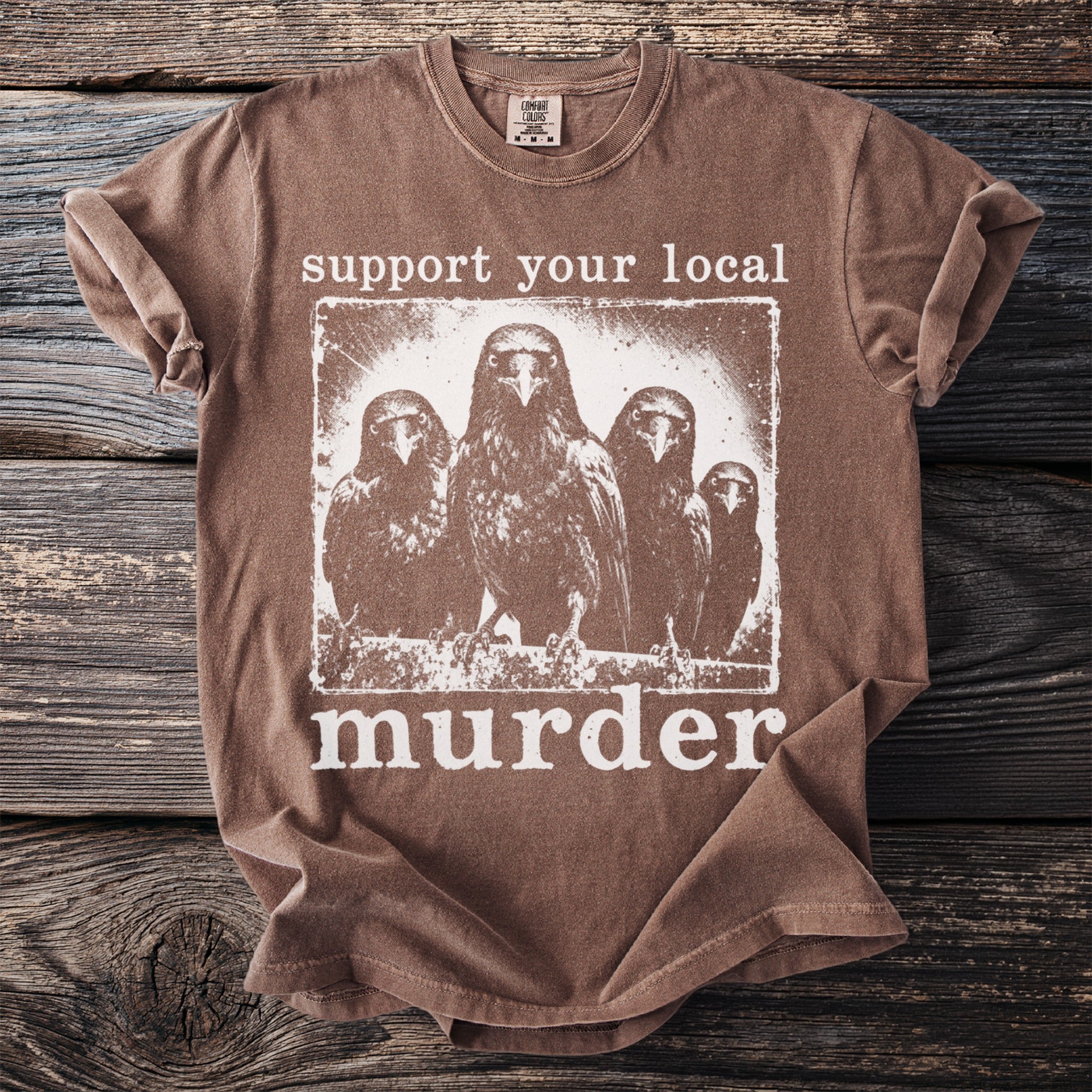 Brown t-shirt with "support your local murder" graphic featuring four crows.