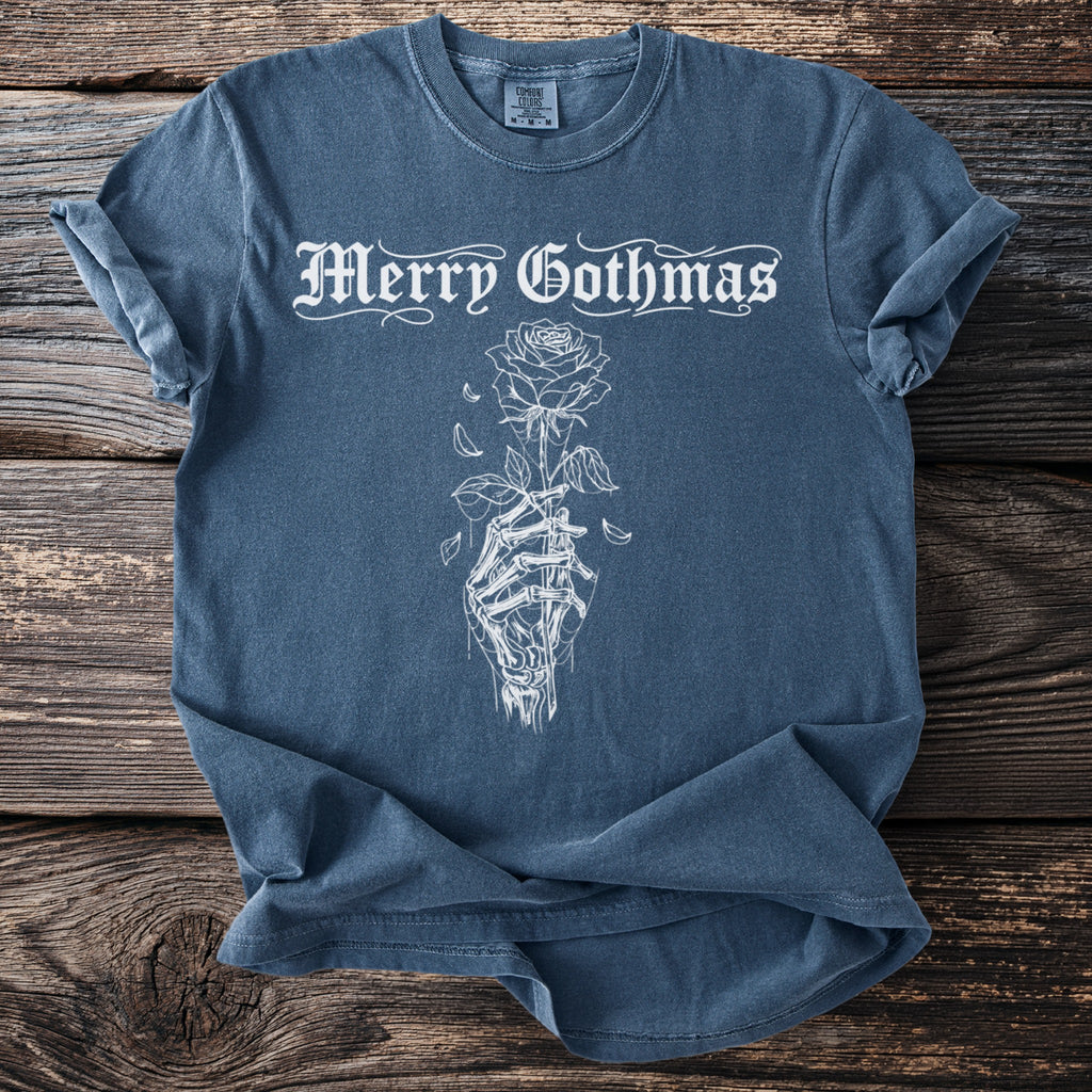 Blue t-shirt with white "Merry Gothmas" text and skeleton hand holding a rose graphic.