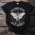 Black t-shirt with text "God forbid women have hobbies" and a moth graphic.