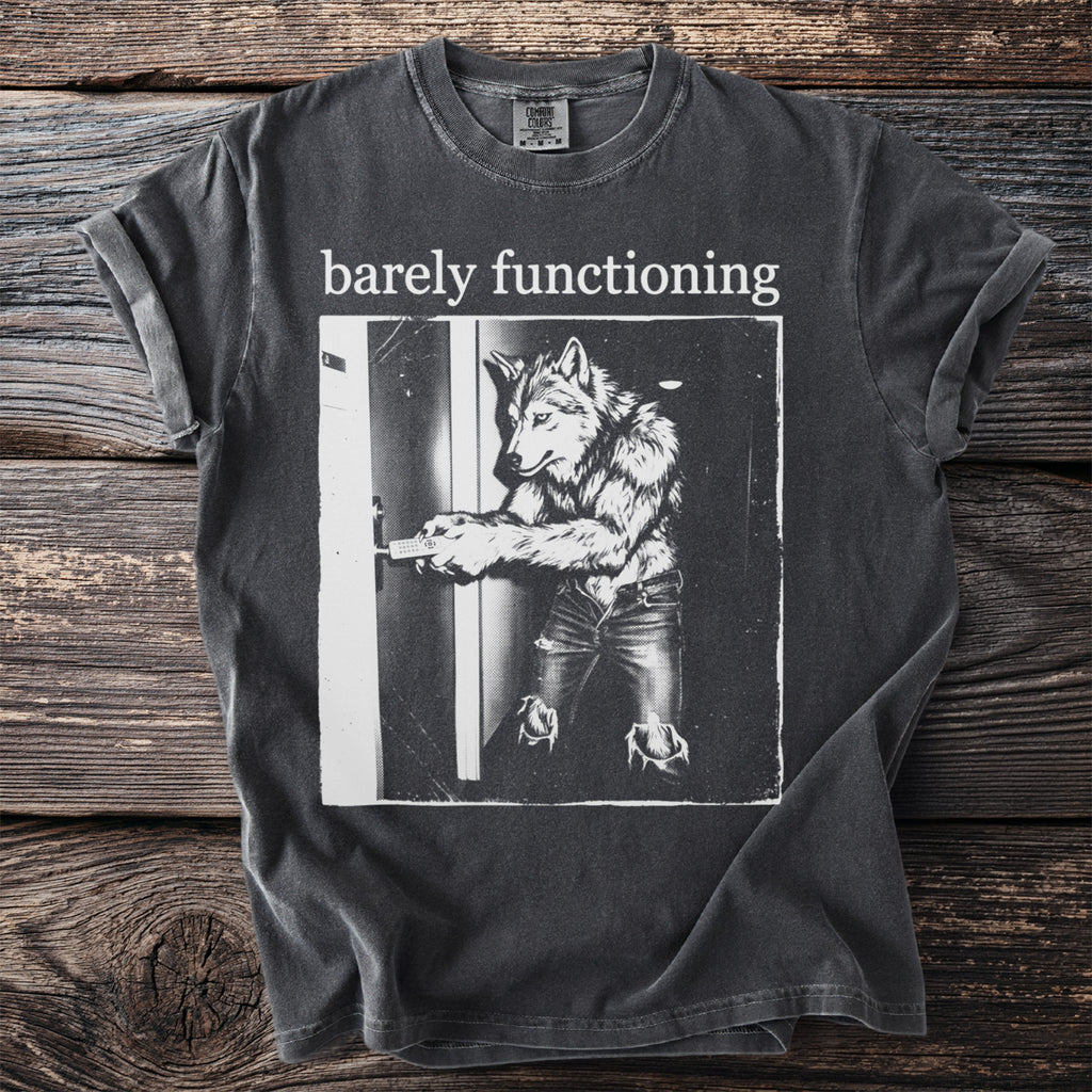 Dark grey t-shirt with "barely functioning" text and a wolf-man opening a door.