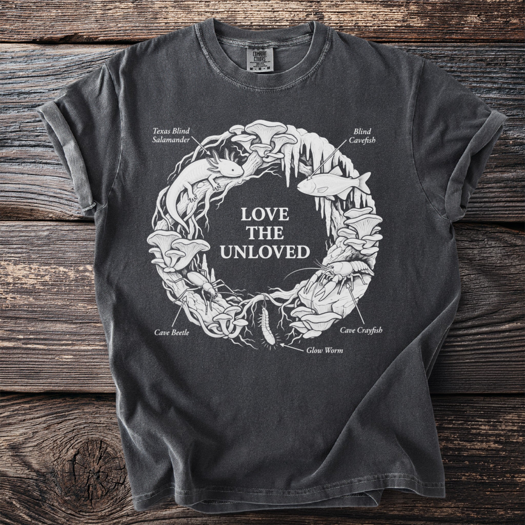 T-shirt with "Love The Unloved" circle art of cave animals and mushrooms.