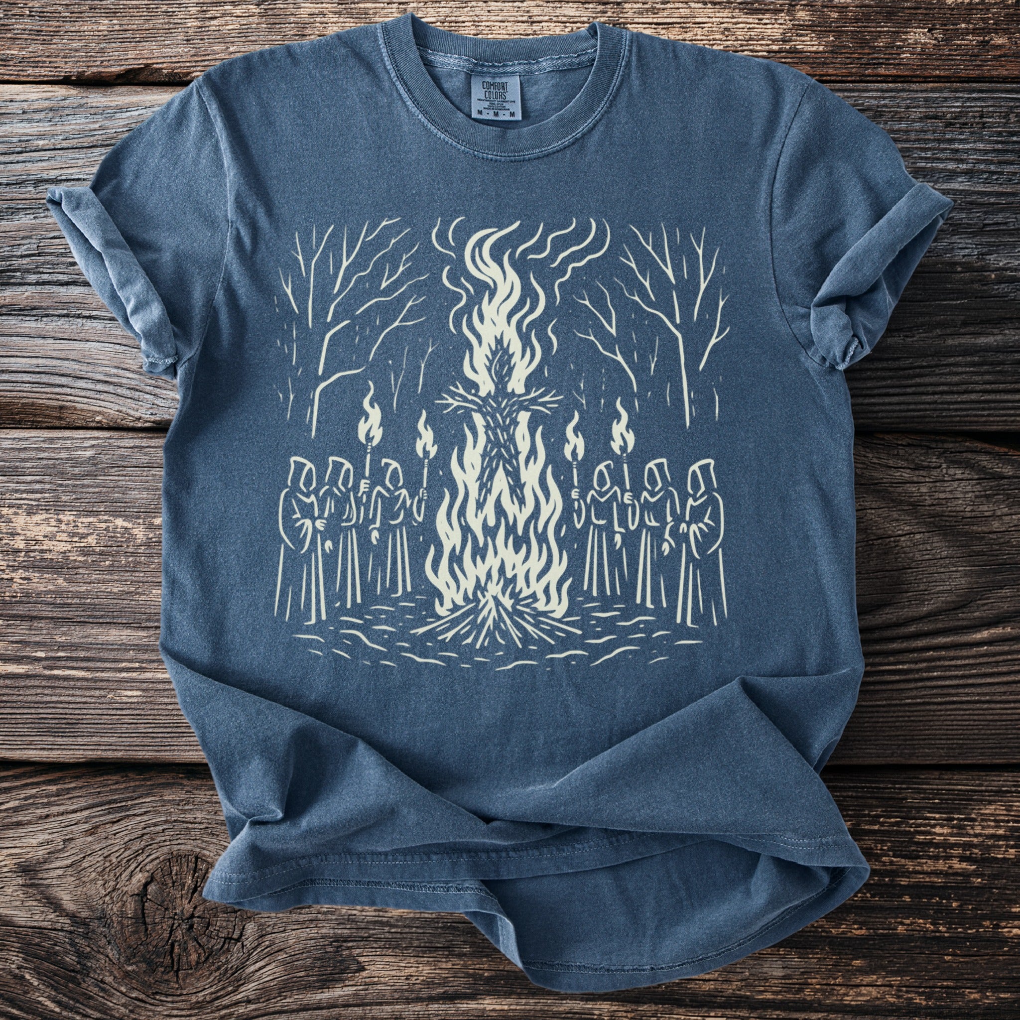 T-shirt with a white graphic of robed figures holding torches around a bonfire.