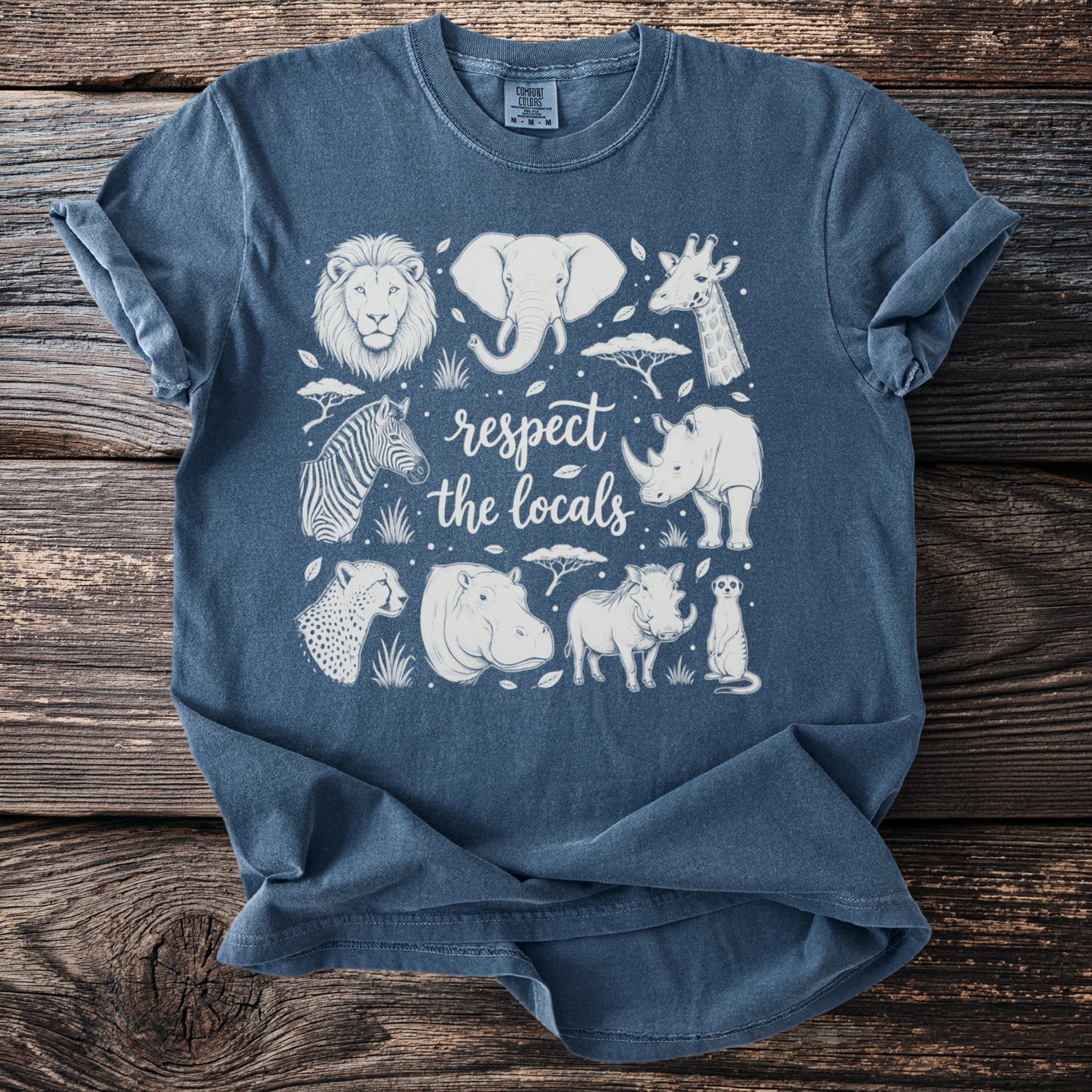 Blue t-shirt with line art of African animals and text "respect the locals".