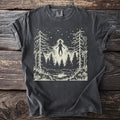 Dark gray t-shirt with an alien hovering over a forest and lake at night.