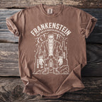 Brown t-shirt with a white Frankenstein monster graphic and text.