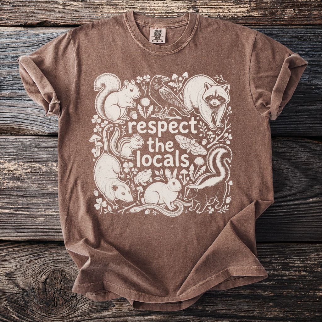 Brown t-shirt with white graphic of woodland animals and text "respect the locals".