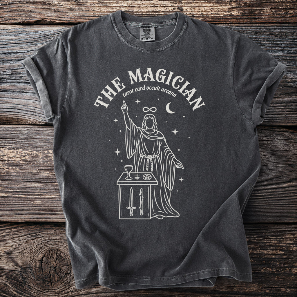 Dark gray t-shirt with "The Magician" tarot design featuring a robed figure and occult symbols.